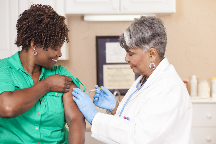 A woman receives her flu shots in Troy, MI
