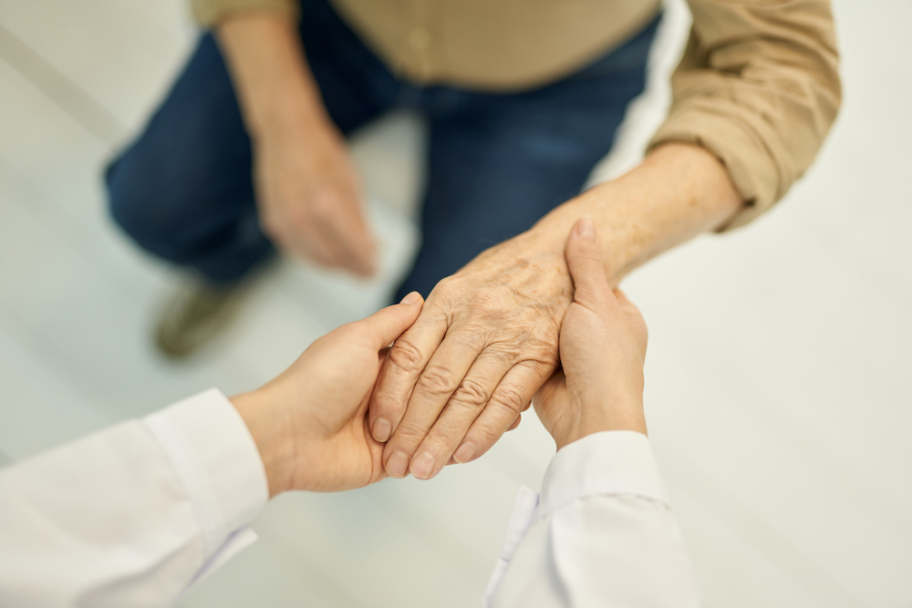 doctor inspects patient's hand for geriatric care in Sterling Heights