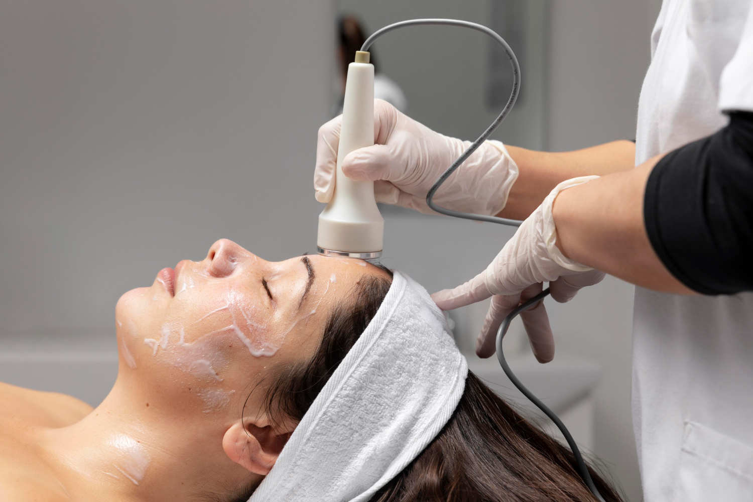 A woman lying down participating in a Cryofacial Near Royal Oak, MI, which is one of our best Facials near Macomb, MI at Tri-County Medical Clinic.